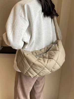 Quilted crossbody bag in khaki with a diamond pattern and silver zipper detail.