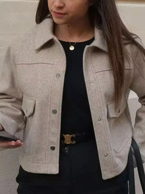 Beige trucker jacket with snap buttons, chest pockets, and collar.