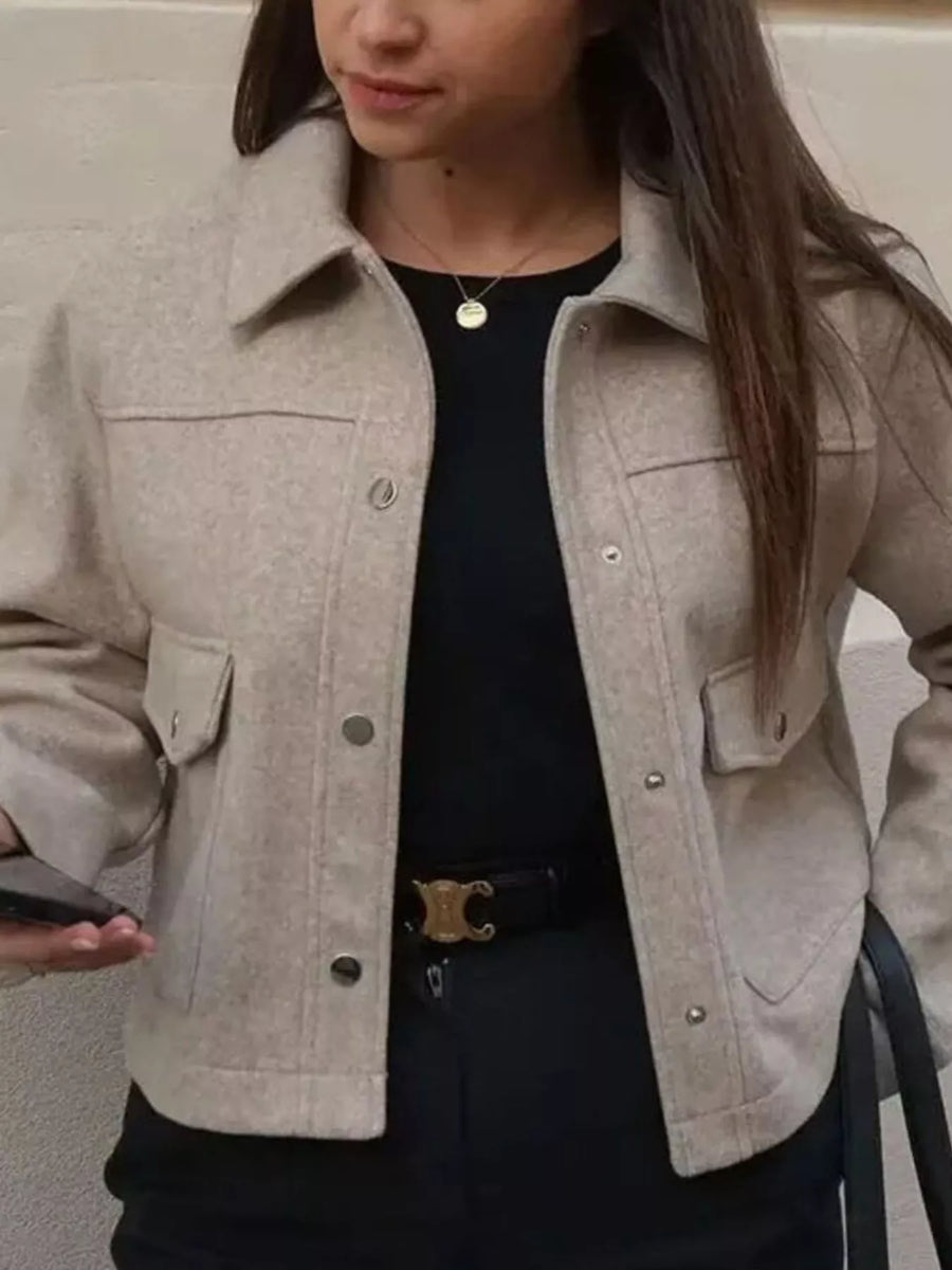 Beige trucker jacket with snap buttons, chest pockets, and collar.