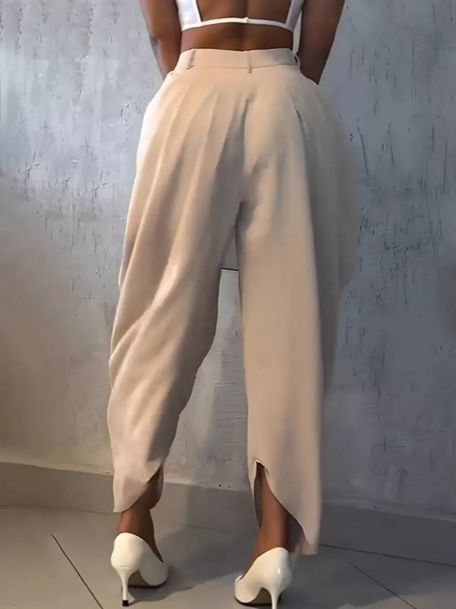 Light khaki sculptural pleated high-waisted pants with a wide leg and split hem.