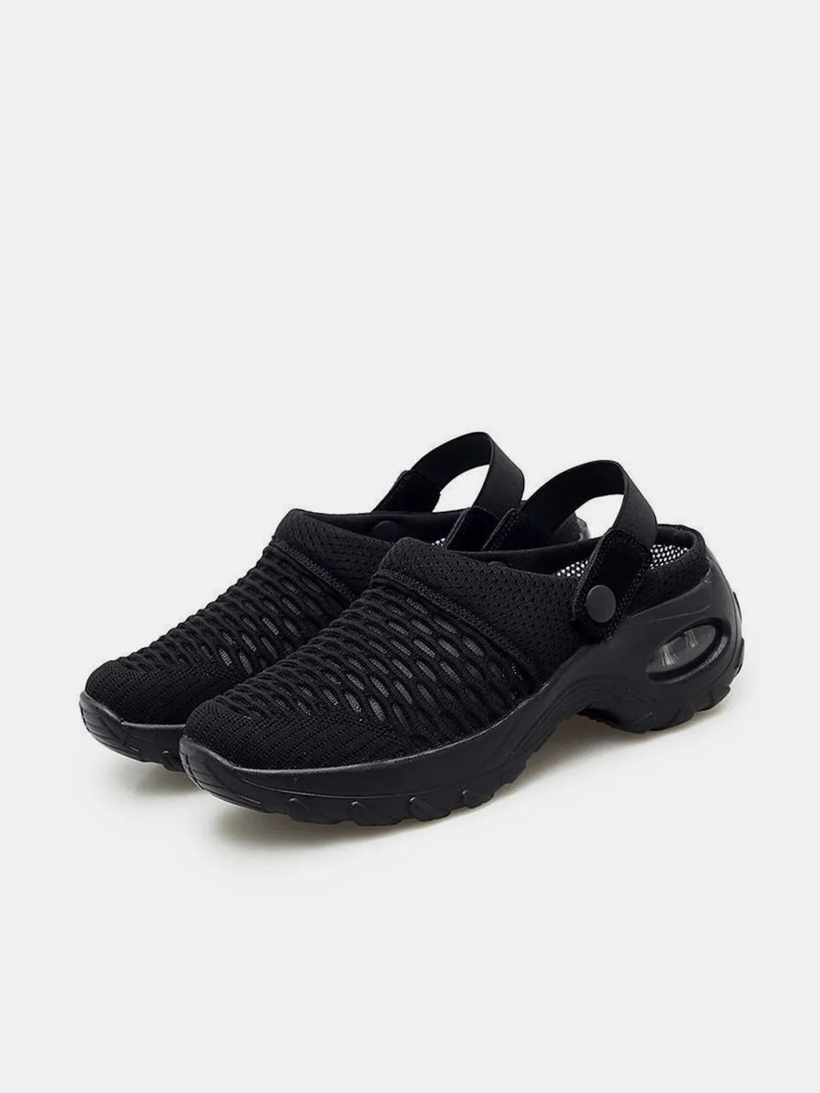 Black air cushion mesh slingbacks with adjustable strap and clear heel detail.