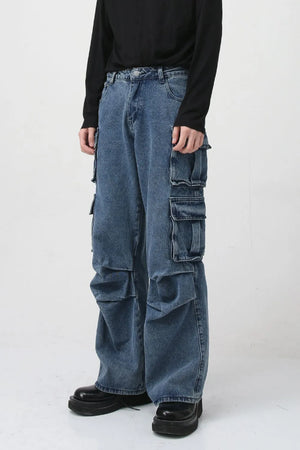 Baggy medium wash denim cargo pants with multiple utility pockets and a relaxed fit.