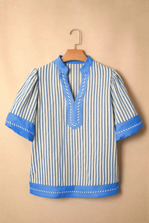 Blue and white striped V-neck shirt with decorative stitching and contrast trim