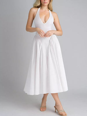 White halter neck midi dress with deep v-neck and full skirt.