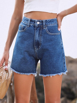 Medium wash denim shorts with frayed hem and white contrast stitching.