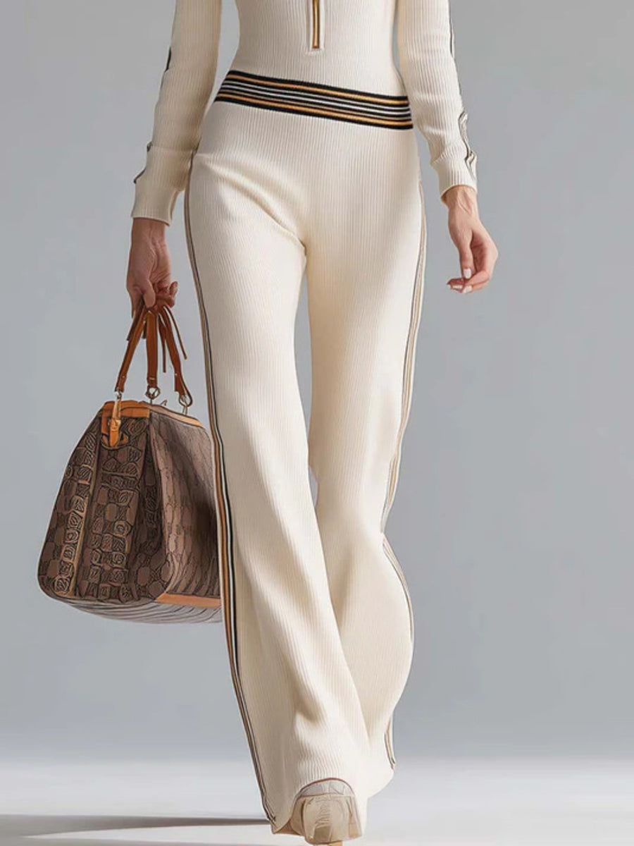Milky white ribbed hooded jumpsuit with striped trim and quarter-zip detail.