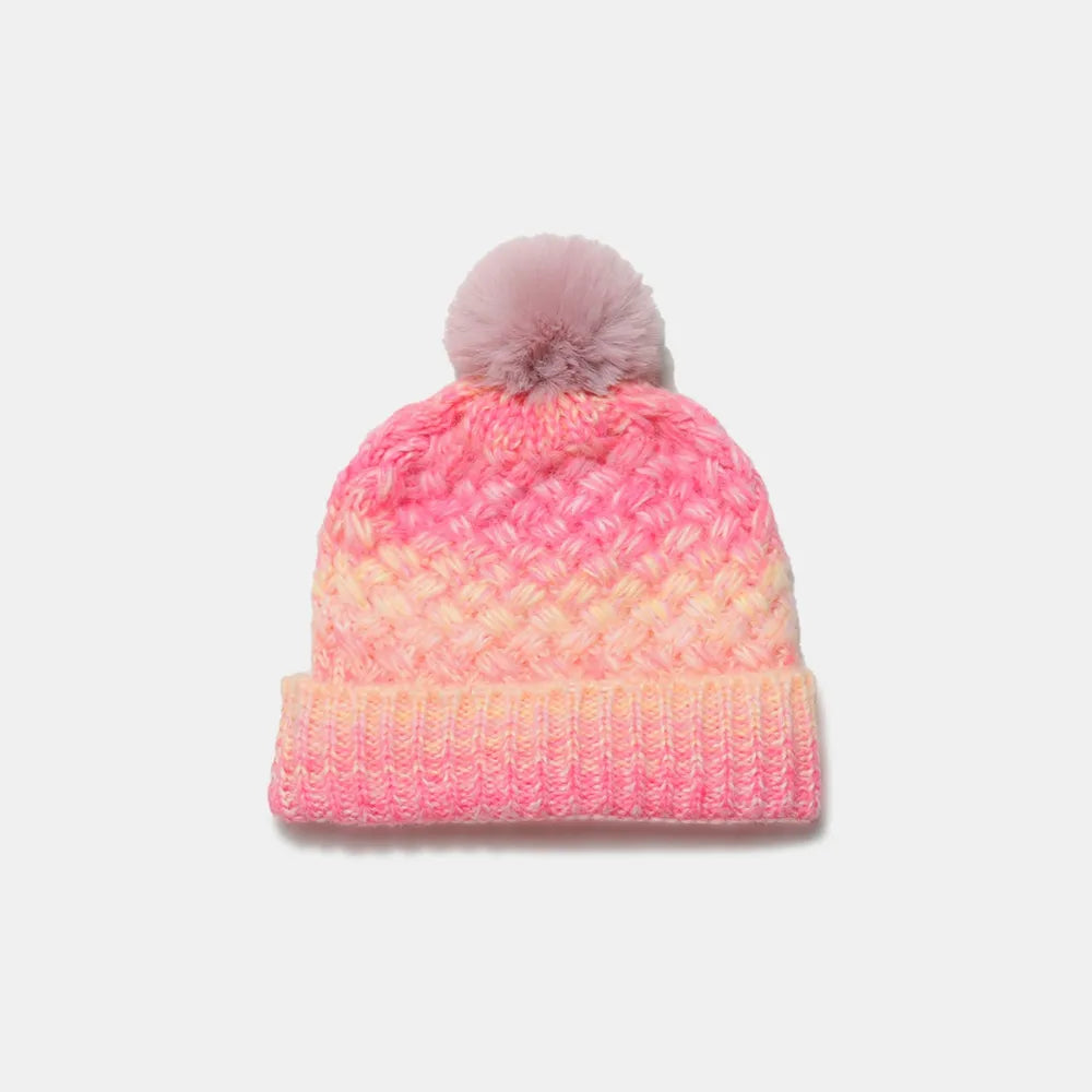 Textured ombre knit beanie in pink and yellow with a pom pom.