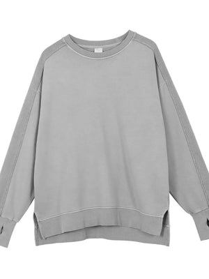 Gray oversized sweatshirt with raw-edge seams and crew neck.