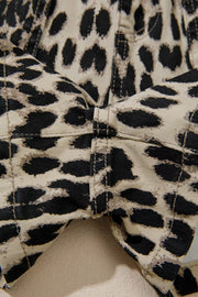 Denim shorts with leopard print and lace-up detail.