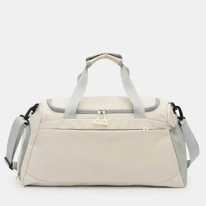 Beige duffel gym bag with grey trim and dual zippers, adjustable shoulder strap.