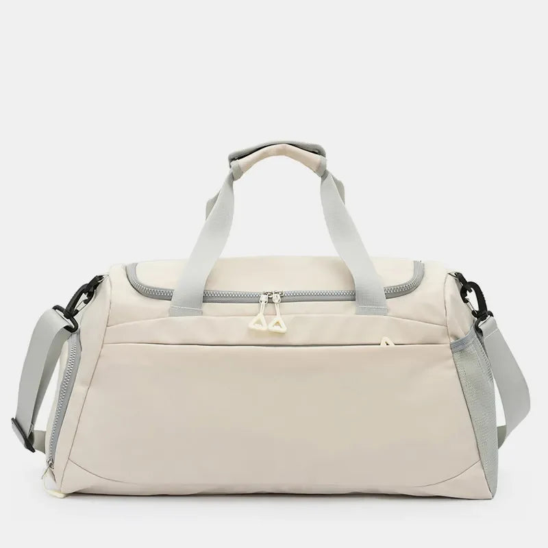 Beige duffel gym bag with grey trim and dual zippers, adjustable shoulder strap.