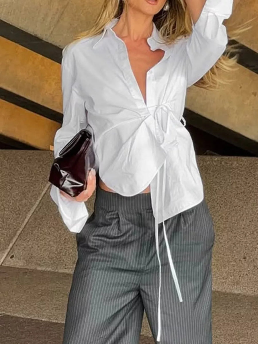 white wrap top with buttoned cuffs and long sleeve