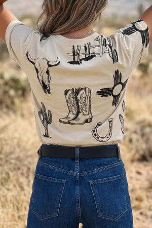 Cream crew neck t-shirt with western graphic print including cowboy boots, bull skull, cactus, and horseshoe.