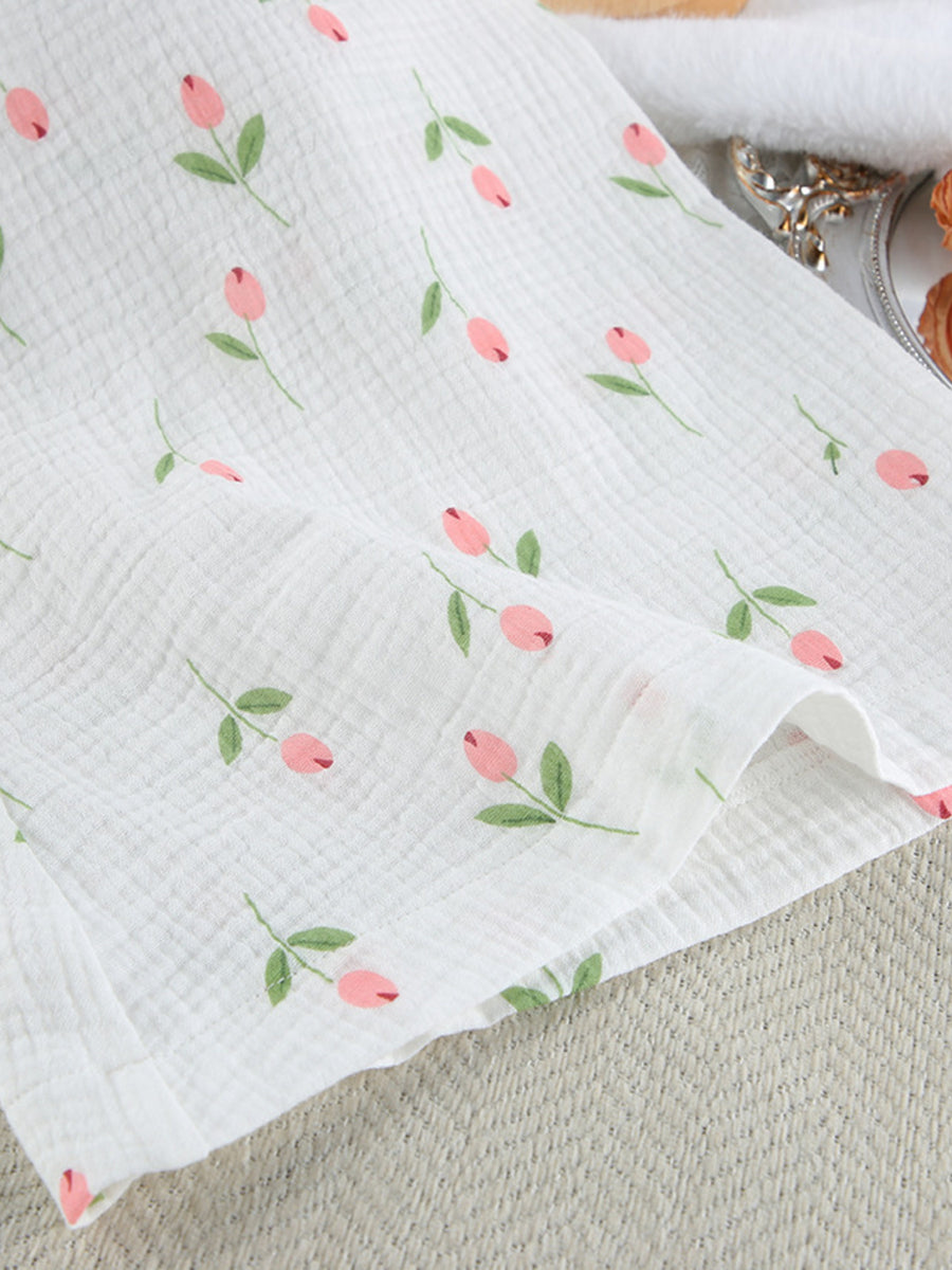 Floral print cotton robe with pink tulip pattern and green leaves on white gauze fabric.