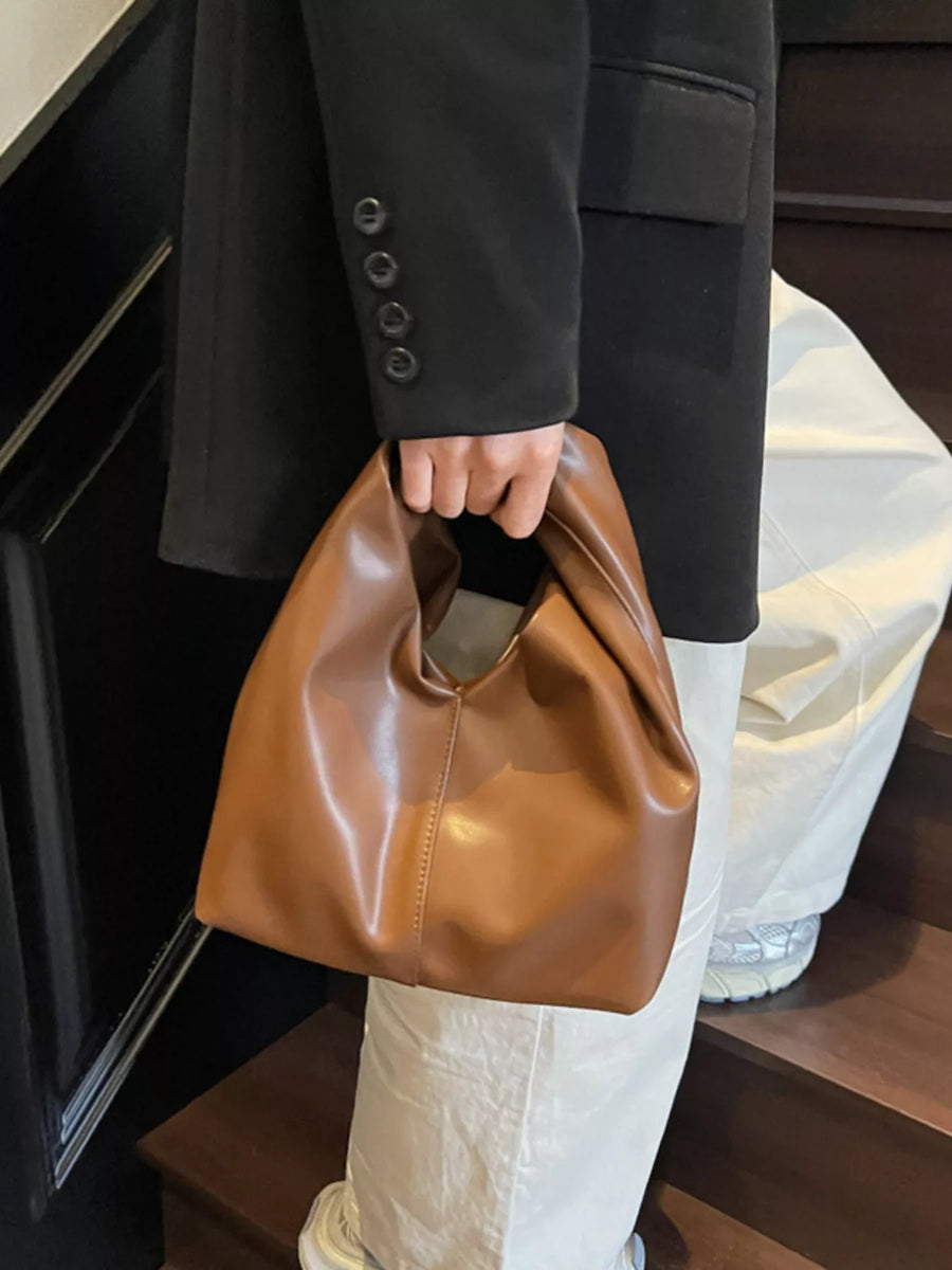 Brown leather shoulder bag with knot handle and slouchy design