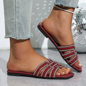 Burgundy open-toe flat sandals with dazzling rhinestone criss-cross straps.