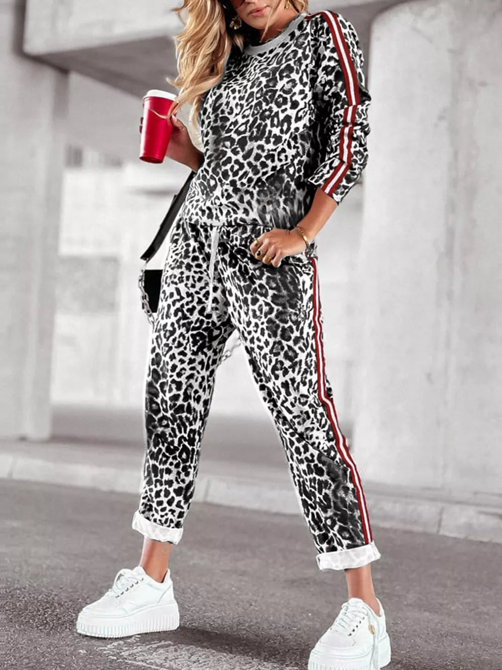 Leopard print two-piece set with red stripe detail on sleeves and pants.