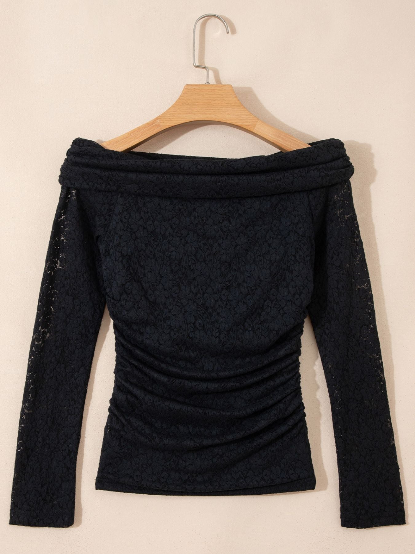 Black lace off-shoulder slim maternity shirt with ruched sides and long sleeves.