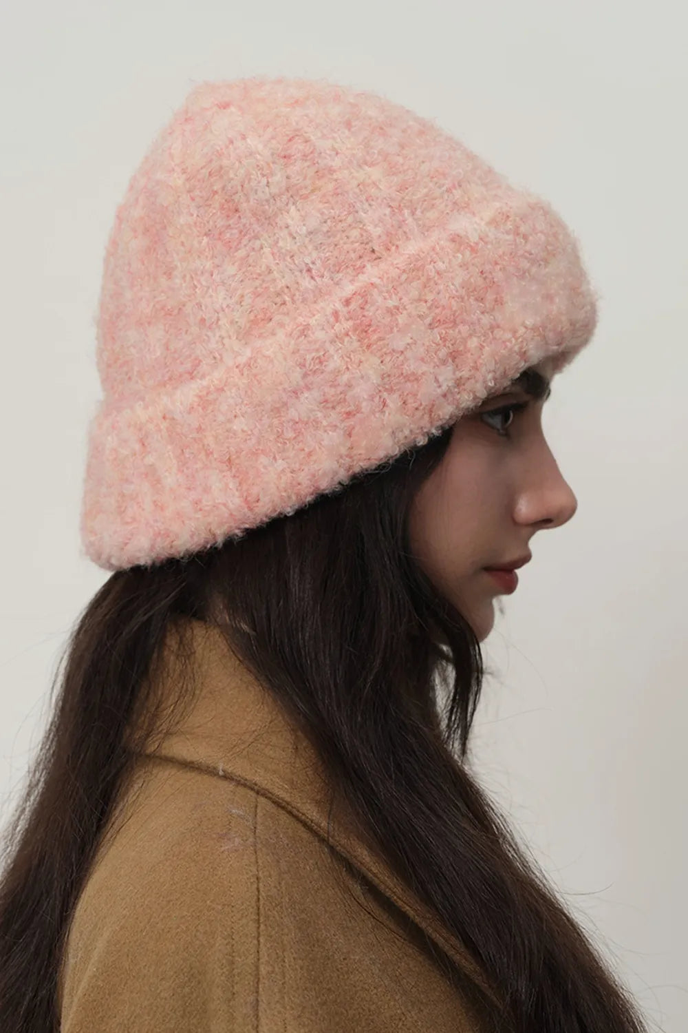 Textured bouclé knit beanie in a soft pink hue, featuring a casual, cozy fit.