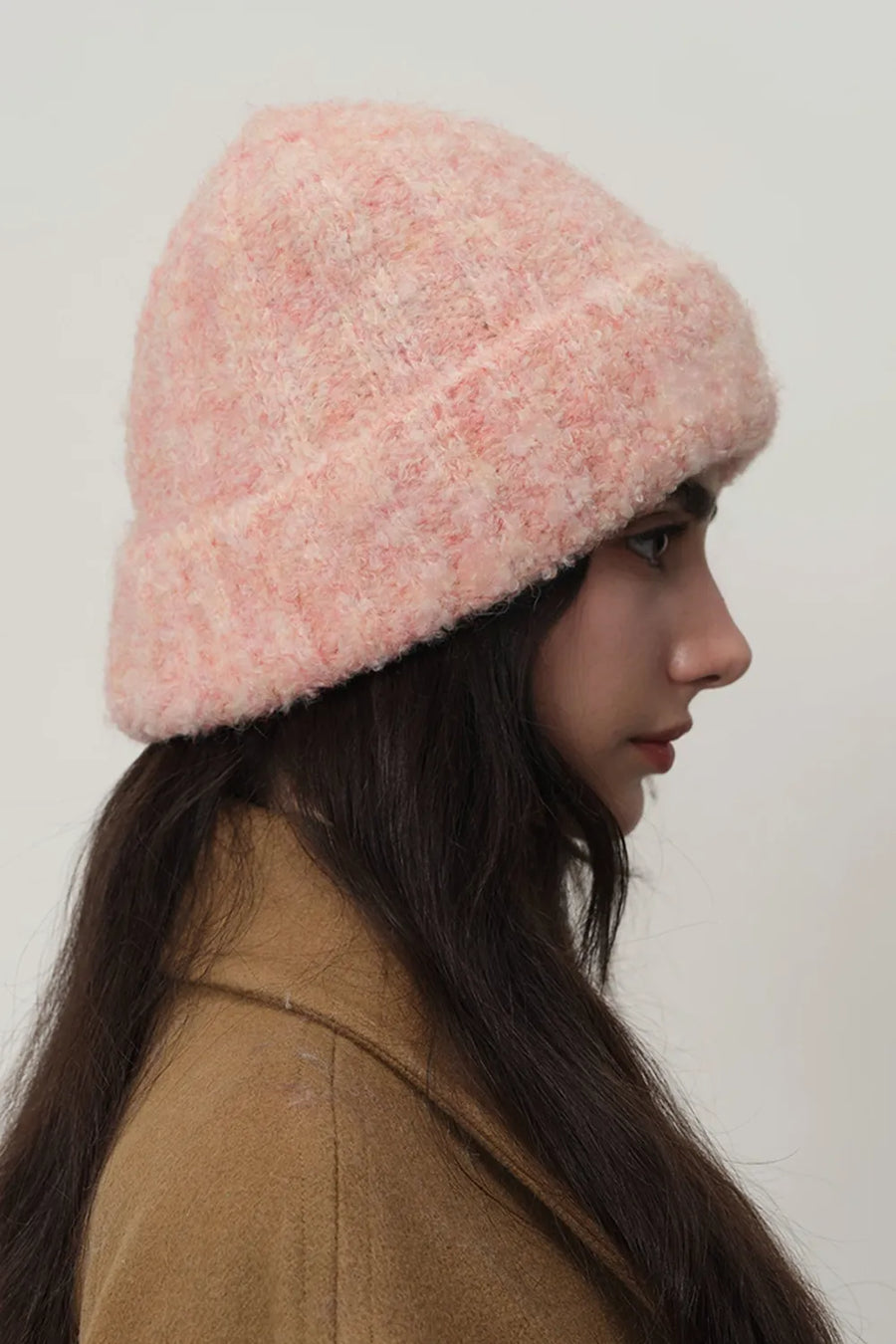 Textured bouclé knit beanie in a soft pink hue, featuring a casual, cozy fit.