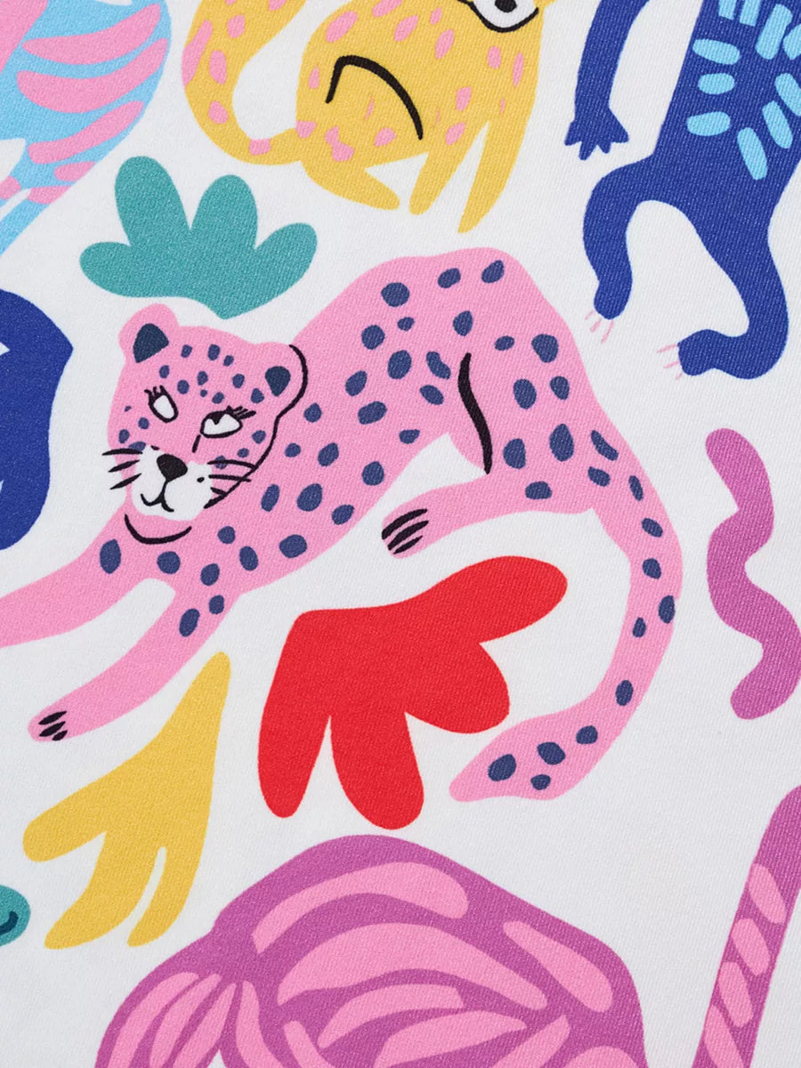 Fabric with a playful pink leopard print and abstract shapes in yellow, blue, and red.