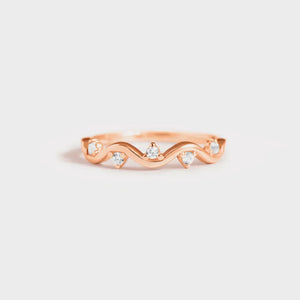Rose gold band ring with wavy design and small clear stones