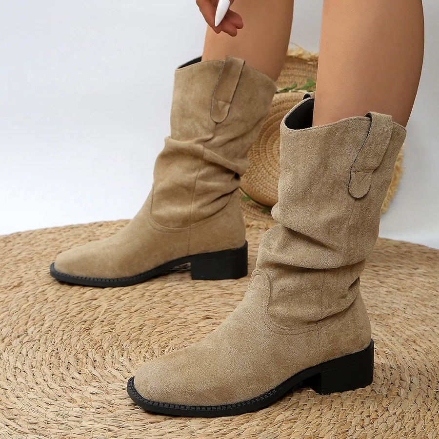 Slouchy khaki suede ankle boots with a low block heel and western-inspired details.