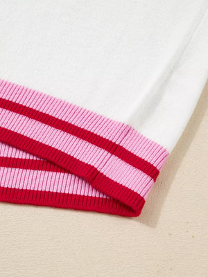 White sweater with pink and red striped ribbed trim
