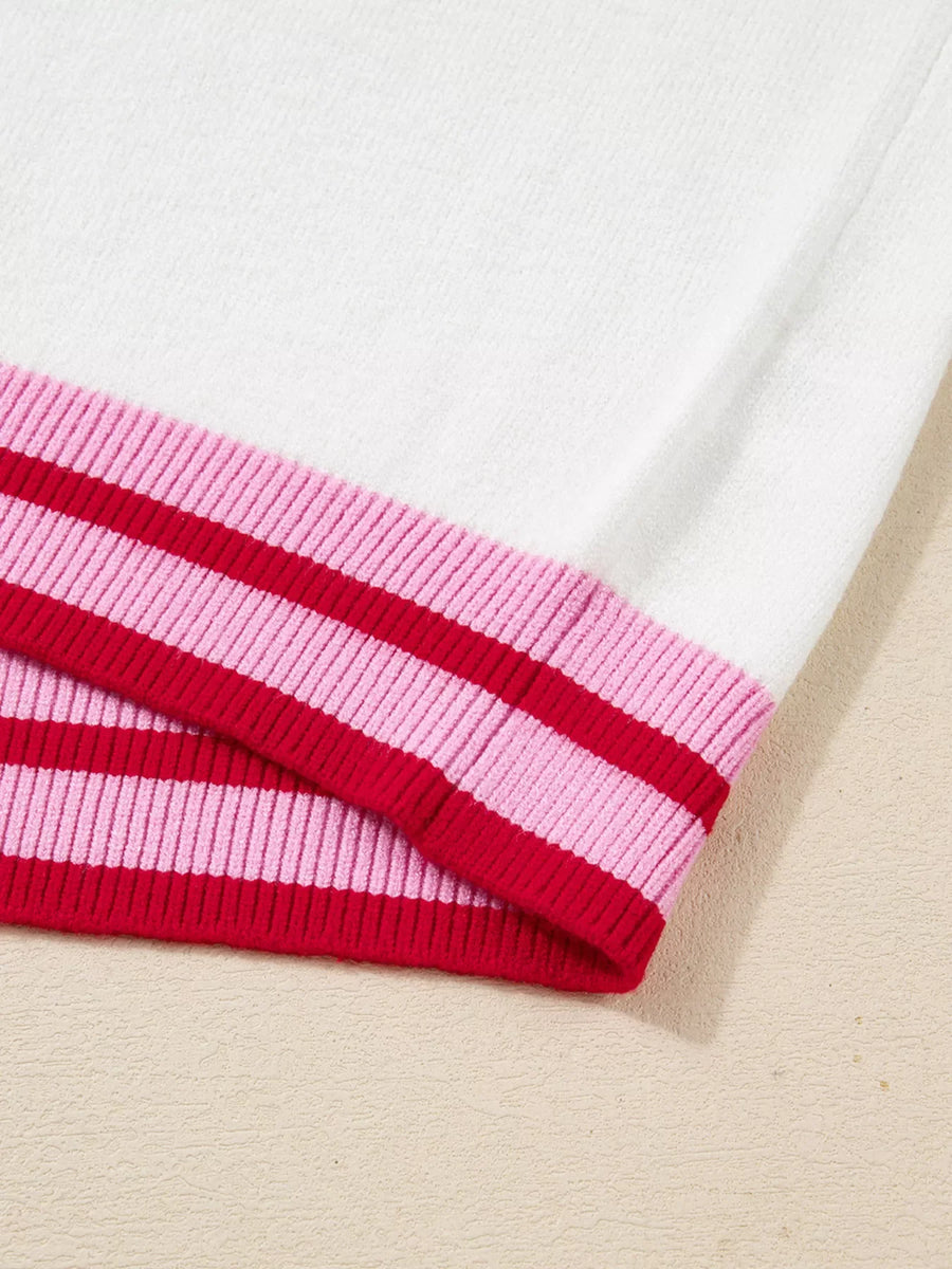 White sweater with pink and red striped ribbed trim