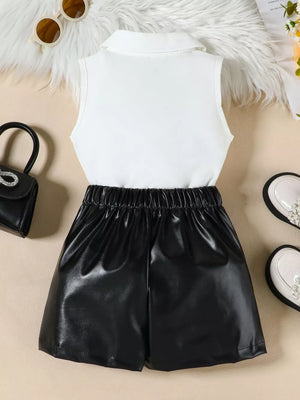 Girls' black faux leather skort with elastic waist and white collared sleeveless top.