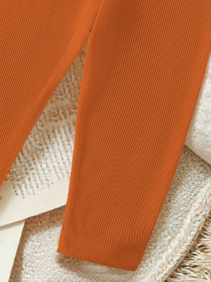 Orange ribbed baby pants with a comfortable fit