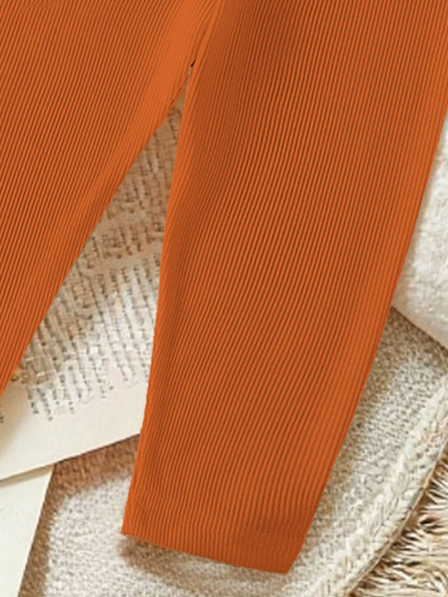 Orange ribbed baby pants with a comfortable fit