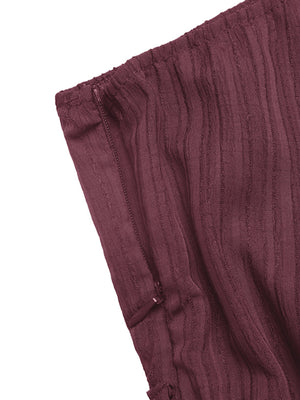 Chic one-shoulder romper in burgundy with vertical stripes and side zipper detail.