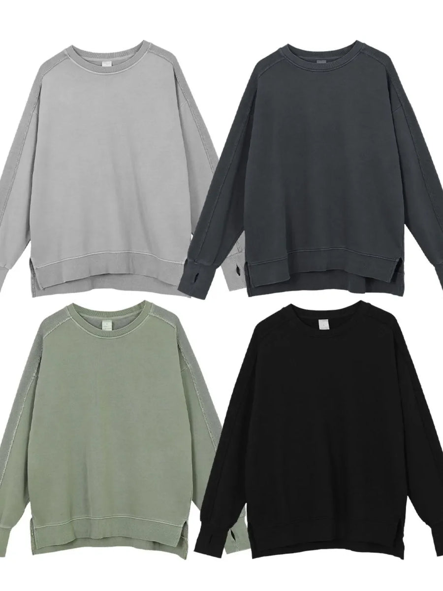 Oversized sweatshirt in dark gray, sage, black, and gray with raw-edge seams and crew neckline.