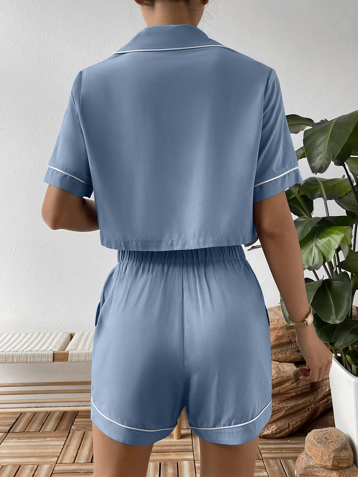 Light blue cropped pajama set with contrast trim, short sleeves, and elastic waist shorts.
