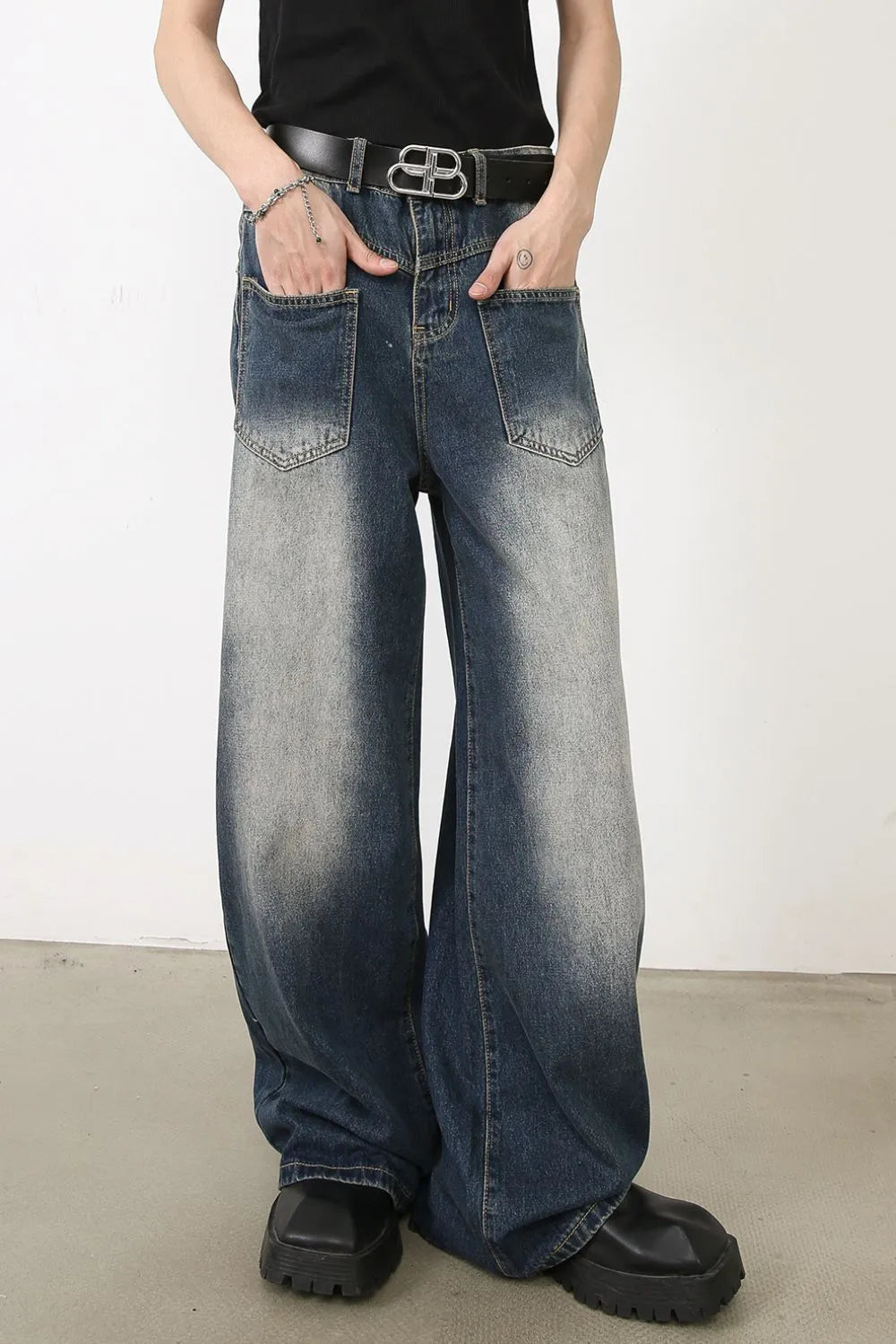 Faded wash palazzo jeans in medium blue denim with a relaxed fit and wide leg.