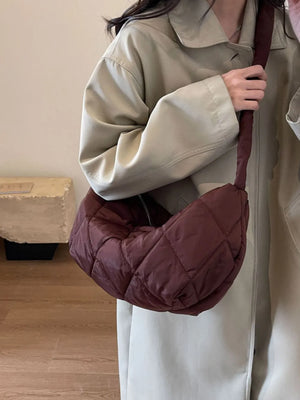 Quilted crossbody bag in brown with a diamond pattern and a wide strap.