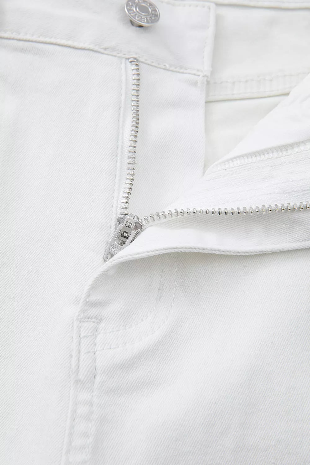 White denim jeans with zipper detail and button closure