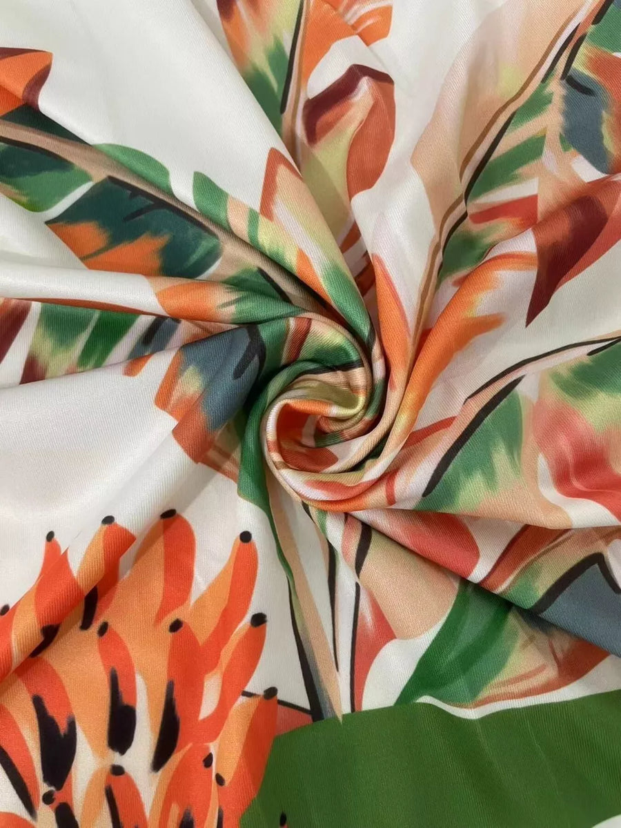 Tropical print maxi dress fabric with cutouts and a slit detail.