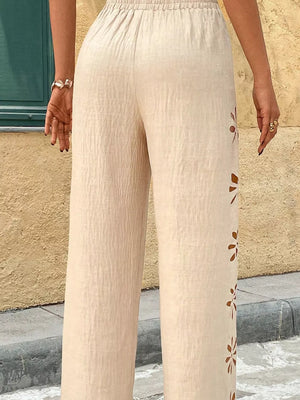 Beige linen pants with cutout floral detail and elastic waist