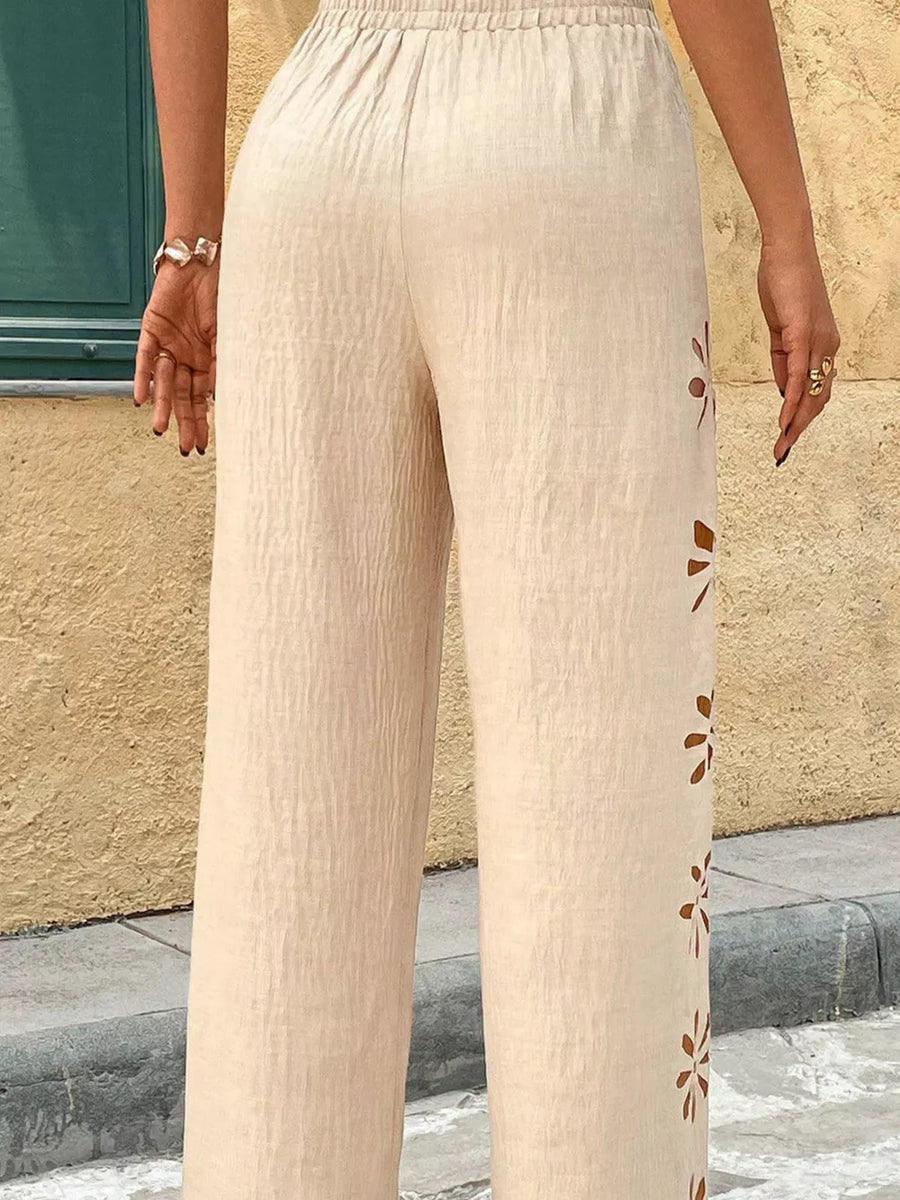 Beige linen pants with cutout floral detail and elastic waist
