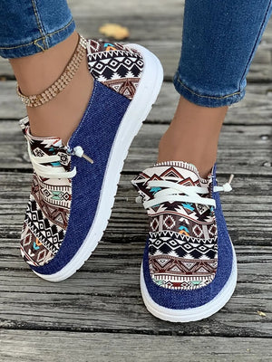Aztec print canvas slip-on shoes in light indigo with white laces and soles.
