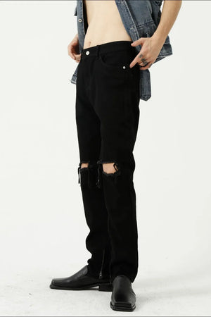 Black denim jeans with distressed knees and a modern straight leg cut.