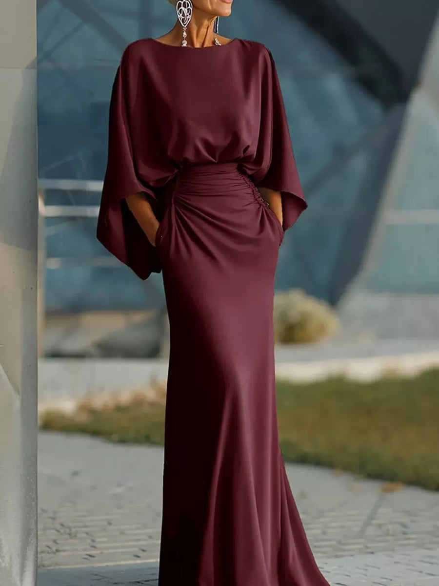 Sophisticated batwing sleeve maxi dress in burgundy with ruched waist detail and pockets.
