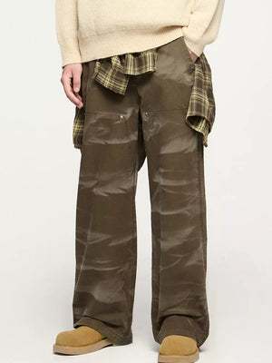Men's olive green cotton cargo pants with a pocketed design and relaxed fit.