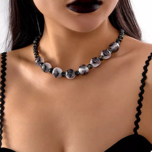 white jewelry set featuring beaded and bat motif