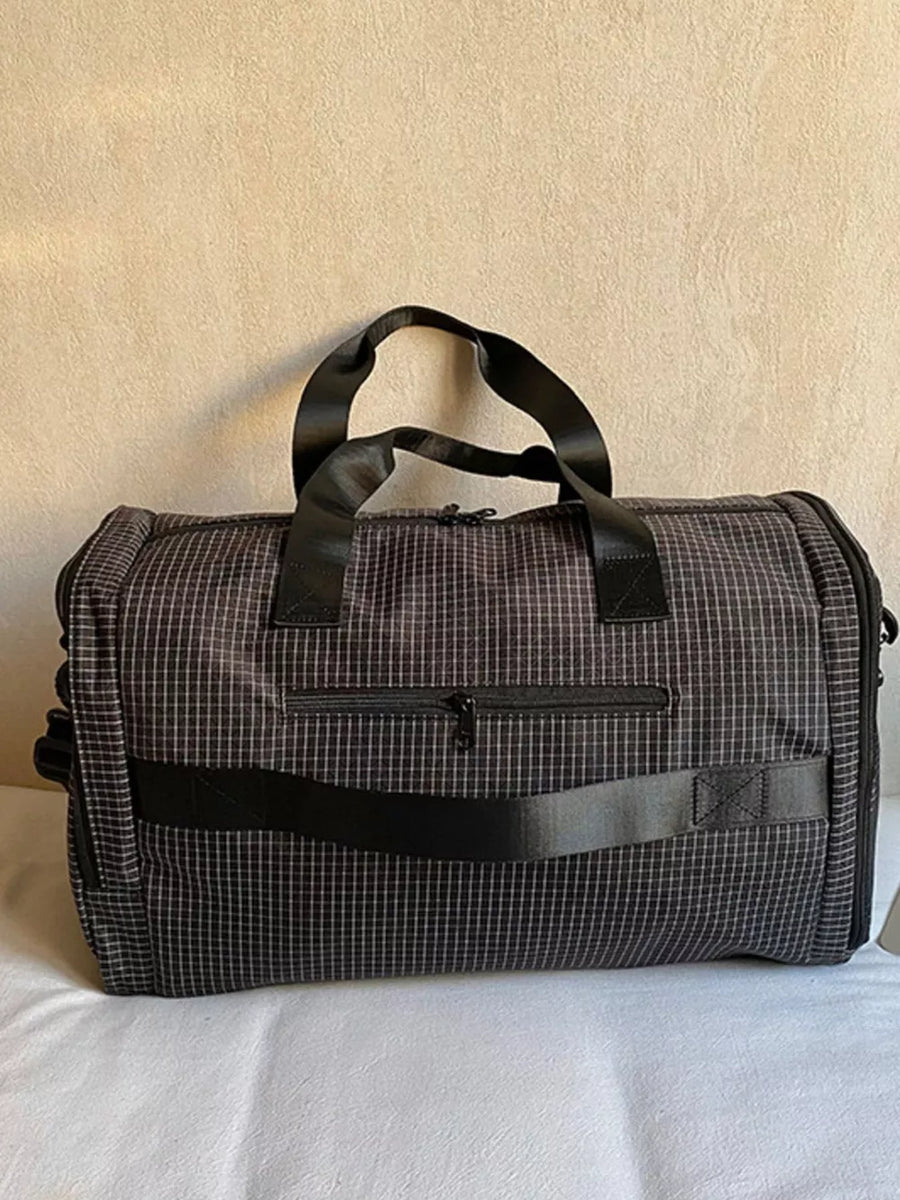 Chic medium duffel bag with plaid pattern and zippered front pocket.
