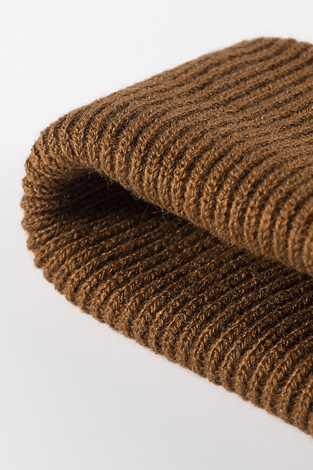 Brown ribbed knit acrylic beanie, showing texture detail.