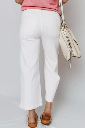White relaxed fit ankle-length denim jeans with pearl embellishments on the side.