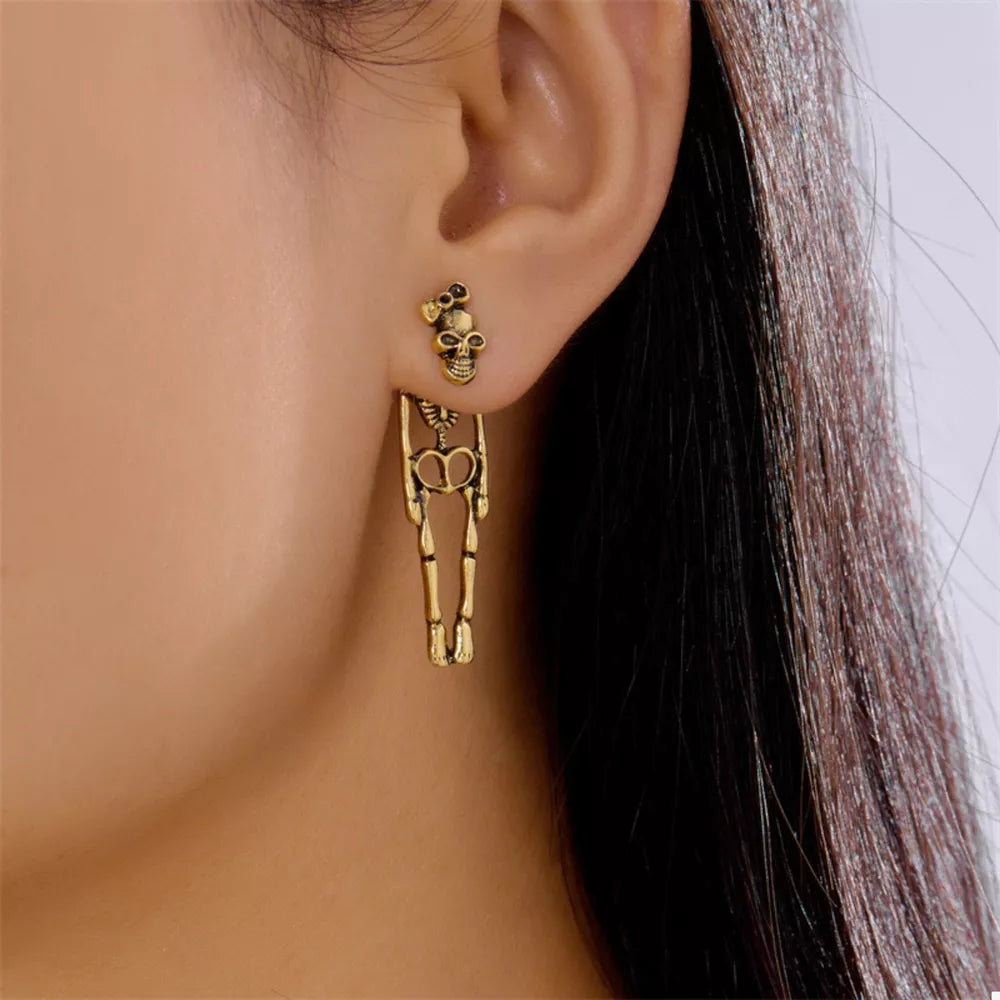 gold earrings featuring skeleton design and skeleton